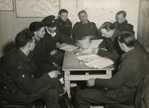The Buckham crew at debriefing after Juvisy, 18APR44. Left to right, they are: F/S EJ Holden, Sgt W Sinclair, F/O RW Broad, F/O BA Buckham, F/O EH Giersch, F/S LJ Manning, P/O A Giles (Intelligence Officer) and F/O JW Muddle